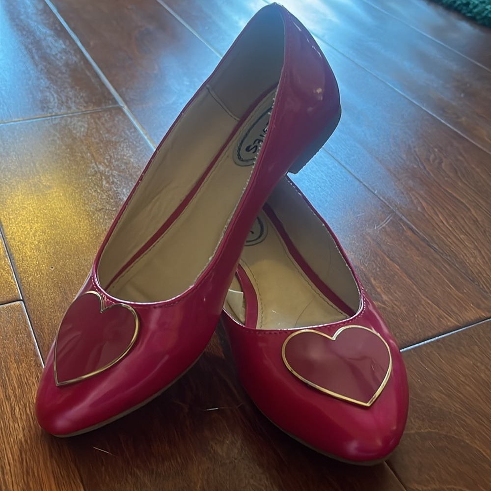 Cute girls’ shoes with pink heart detail.